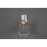 A MODERN 18CT GOLD DIAMOND AND CULTURED PEARL DRESS RING, estimated total modern round brilliant cut