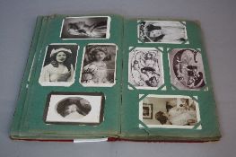 AN EDWARDIAN POSTCARD ALBUM, containing approximately two hundred and seventy three postcards,