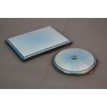 A MATCHING GEORGE VI SILVER AND TWO TONE BLUE ENAMEL POWDER COMPACT AND CIGARETTE CASE, the circular