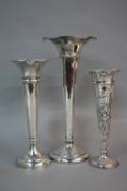 A GEORGE V WILLIAM COMYNS & SONS SILVER TRUMPET SHAPED VASE, embossed floral decoration, London