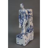 A MODERN CERAMIC BOOKEND MODELLED AS A MALE NUDE LEANING BACK AGAINST THE UPRIGHT, transfer