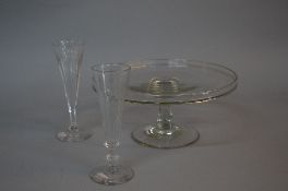 A VICTORIAN CLEAR GLASS TAZZA, plain stem, circular foot, ground pontil, diameter approximately