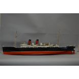 A POWERED MODEL OF A TWO FUNNEL OCEAN LINER, red and black livery similar to Cunard, of wooden and