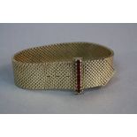 A MID-LATE 20TH CENTURY 9CT GOLD RUBY BRACELET, wide mesh link designed as a belt, feature ruby