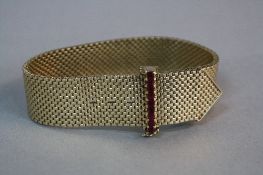A MID-LATE 20TH CENTURY 9CT GOLD RUBY BRACELET, wide mesh link designed as a belt, feature ruby