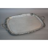 A GEORGE V SILVER RECTANGULAR TWIN HANDLED TRAY, gadrooned, shell and acanthus cast handles and rim,
