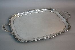 A GEORGE V SILVER RECTANGULAR TWIN HANDLED TRAY, gadrooned, shell and acanthus cast handles and rim,