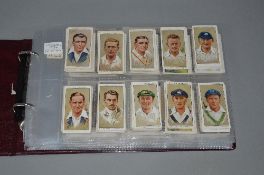 AN ALBUM OF CIGARETTE CARDS, including Players Cricketers, 1934, Gallaher Dogs, second series,