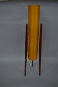 A 1960'S FLOORSTANDING 'ROCKET LAMP', yellow fibreglass shade (split horizontally), on three teak