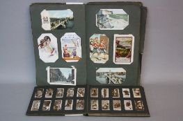 AN EDWARDIAN POSTCARD ALBUM, containing approximately one hundred and sixty five cigarette cards,