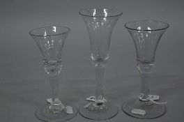 A MID 18TH CENTURY WINE GLASS, bell shaped bowl, plain stem, height approximately 18.5cm, together