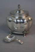 AN EDWARDIAN SILVER TEA CADDY, of lobed oval form, hinged cover, gadrooned rims, on four cabriole