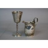 AN EDWARDIAN SILVER HELMET SHAPED CREAM JUG, reeded rim, foliate scroll and strap handle, makers