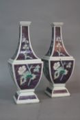 A PAIR OF ORIENTAL PORCELAIN VASES, of shaped square outline, purple ground enamelled with floral