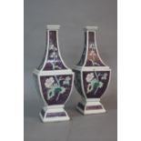 A PAIR OF ORIENTAL PORCELAIN VASES, of shaped square outline, purple ground enamelled with floral