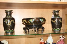 A CLOISONNE GARNITURE, to include a pair of vases and a bowl on stand, depicting Dragon scenes,