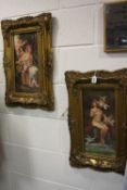 A PAIR OF REPRODUCTION GILT FRAMED PLAQUES, printed with scenes of scantily clad females (2)