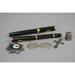 A MIXED BAG, to include two swan pens, two silver 1919 one rupee coins, thimble, cross and badge (