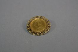 A 1887 HALF SOVEREIGN, in a 9ct mount, approximate weight 7.8 grams