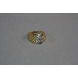 A MODERN GENTS 9CT GOLD DIAMOND SET SIGNET RING, rectangular shaped head, estimated total diamond