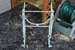 A PAINTED CAST IRON TABLE FRAME