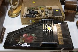 AN AUTO-HARP (with key) and a box of dominoes, darts (feather tipped), cribbage board etc