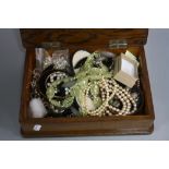 AN OAK BOX, with a quantity of mixed costume jewellery etc