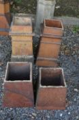 A PAIR OF CHIMNEY POTS, and two treacle glazed bases (4)