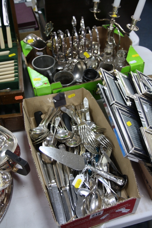 TWO BOXES OF METALWARE, CUTLERY, etc, to include candelabra, four bottled cruet stand, silver