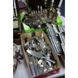 TWO BOXES OF METALWARE, CUTLERY, etc, to include candelabra, four bottled cruet stand, silver