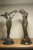 TWO BRONZED NUDE FIGURINES, depicting nude standing on rock holding grape vine and semi-clad