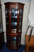 A MODERN MAHOGANY DISPLAY CABINET, with canted angles and single door to top and base, approximate