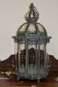 A MODERN OCTAGONAL HANGING LANTERN, with bowed glass and hinged top, approximate height 72cm