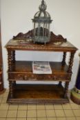 AN EARLY 20TH CENTURY CARVED OAK THREE TIER BUFFET, with raised back, barley twist uprights and