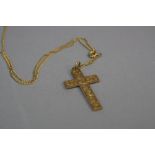 AN EARLY 20TH CENTURY 9CT GOLD CROSS, measuring approximately 40mm x 22mm, fully engraved in a fancy