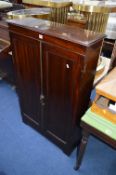 A NARROW MAHOGANY TWO DOOR CABINET, approximate size width 78cm x height 123cm x depth 27cm