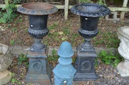 A PAIR OF PAINTED CAST IRON COMPANA GARDEN URNS ON SEPERATE BASES, approximate height 105cm