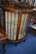 AN OAK DEMI LUNE SINGLE DOOR CHINA CABINET, on ball and claw feet (sd) (key)