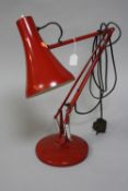 A RED ANGLE-POISE LAMP