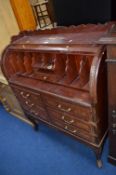A MODERN MAHOGANY AND INLAID ROLL FRONT BUREAU, with metal banding and six various drawers,