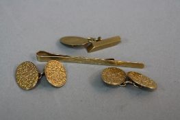 AN EARLY 20TH CENTURY 9CT GOLD PAIR OF CUFFLINKS, each oval fully engraved in a clover leaf pattern,