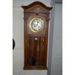 A 20TH CENTURY WALNUT WALL CLOCK, signed Herman Gong (two keys and a pendulum)