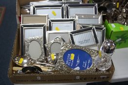 A TRAY OF VARIOUS PHOTOGRAPH FRAMES, a cut glass sifter, cutlery etc