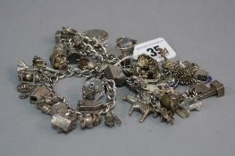 THREE MIXED SILVER CHARM BRACELETS, approximate weight 212 grams