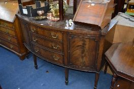 A LARGE VICTORIAN MAHOGANY BOW FRONT SIDEBOARD, with three graduating central drawers, approximate