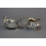 A LATE VICTORIAN SILVER CREAM JUG OF OVAL FORM, gadrooned rim, angular strap handle, worn gilt