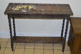 AN EARLY 20TH CENTURY CARVED OAK HALL TABLE WITH UNDERSHELF