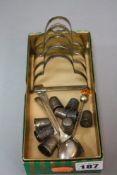 NINE SILVER THIMBLES, including one stamped 'HOVIS BREAD', a five bar silver toast rack,