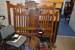 AN EDWARDIAN OAK 4' 6' BED FRAME, with two irons (sd)