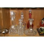 SIX CUT GLASS DECANTERS, to include Waterford, ruby flashed etc (6)